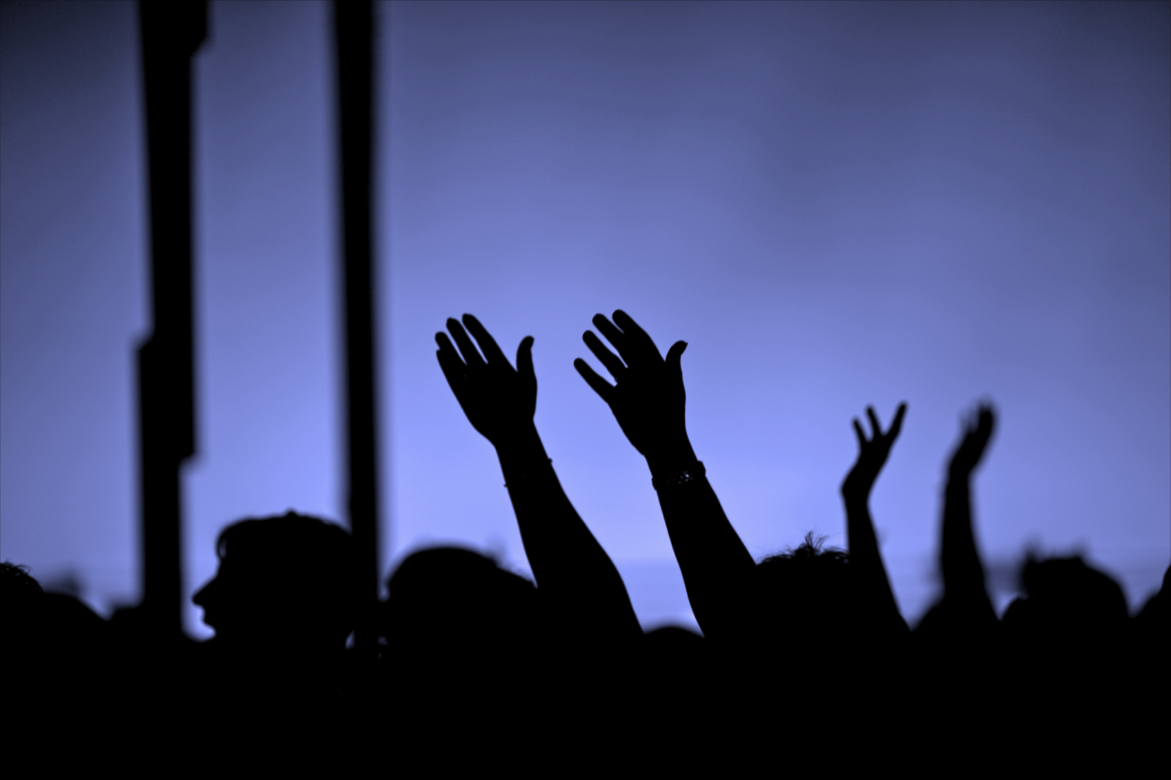 Crowd with hands reaching up