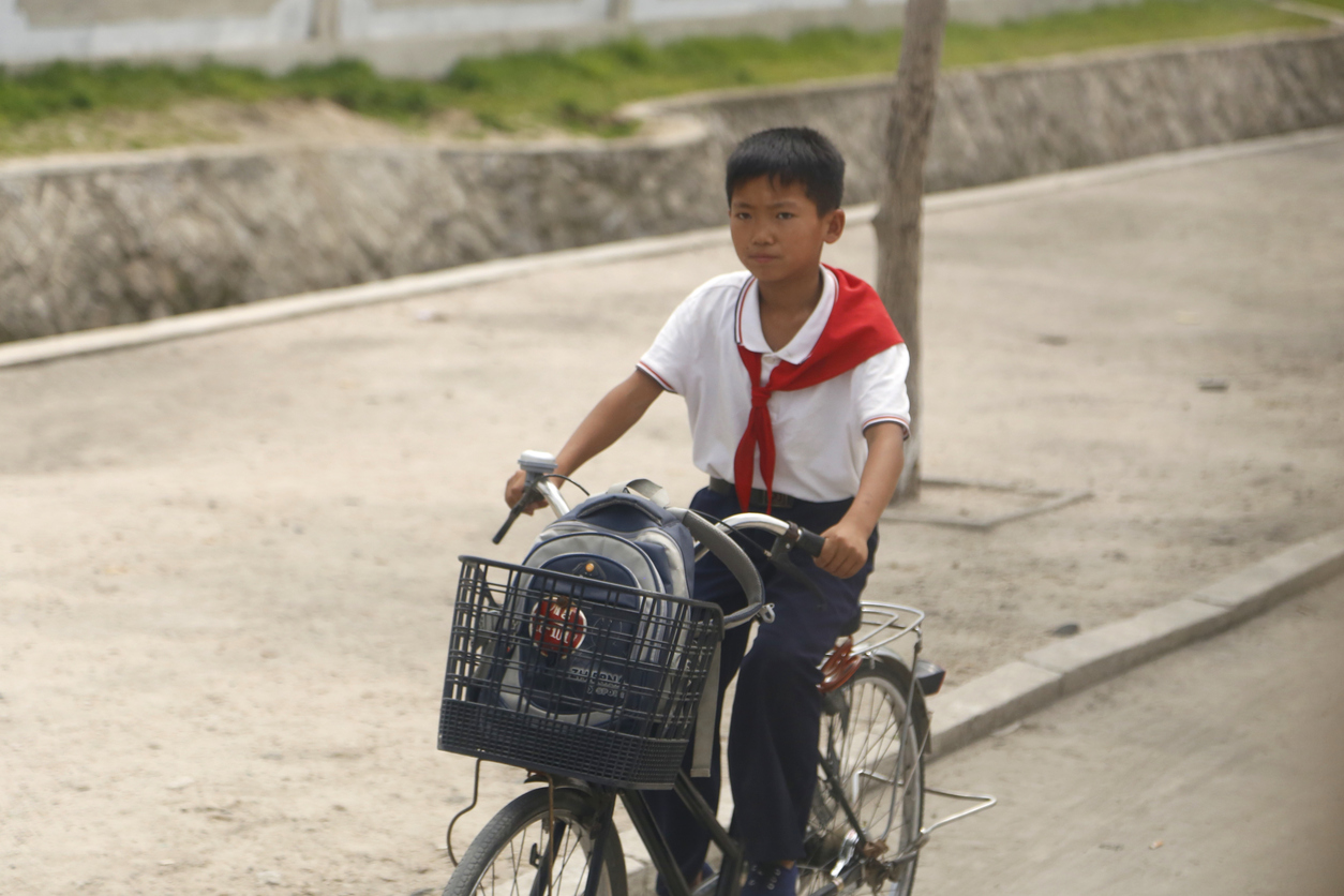 North Korean boy on bike