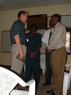 Praying with man in Burundi